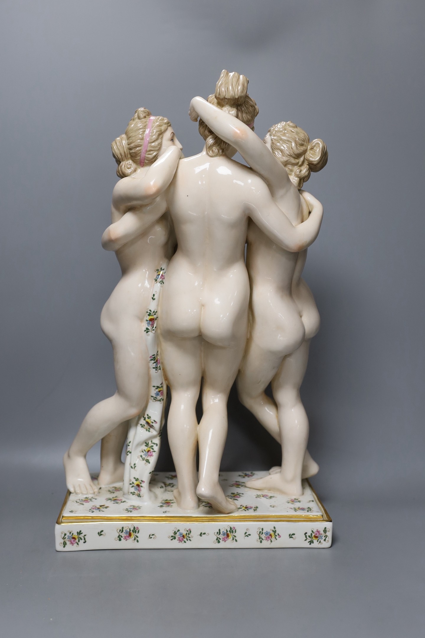 A large German porcelain figure group, the Three Graces, 49cm